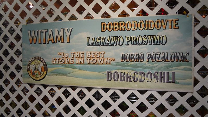 Photo of Polish Market sign welcoming visitors in different languages